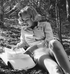 Marilyn Monroe reading in the woods